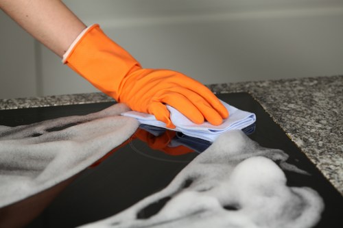 Professional house cleaner vacuuming a modern kitchen